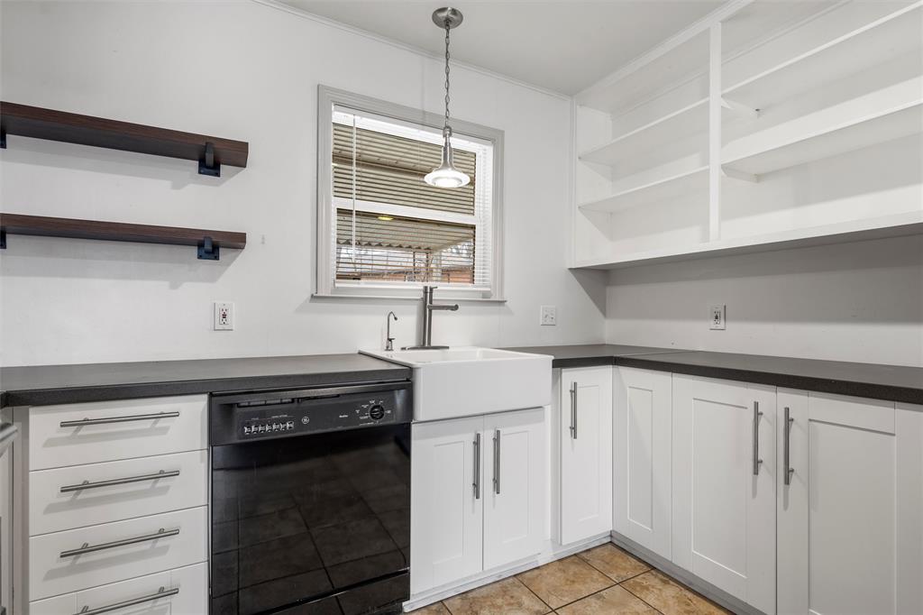 2208 Lake Forest Drive Waco, TX 76708 - Photo 14 of 28 a kitchen with white cabinets and sink