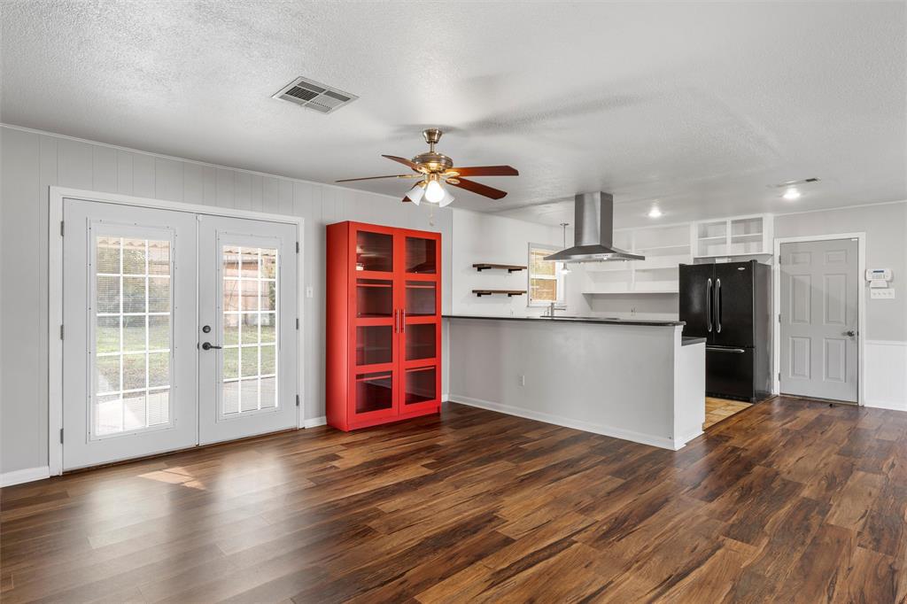 2208 Lake Forest Drive Waco, TX 76708 - Photo 15 of 28 a view of a kitchen with wooden floor and a ceiling fan
