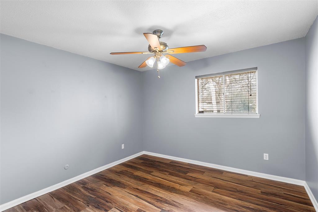 2208 Lake Forest Drive Waco, TX 76708 - Photo 16 of 28 a view of a room with wooden floor and a window