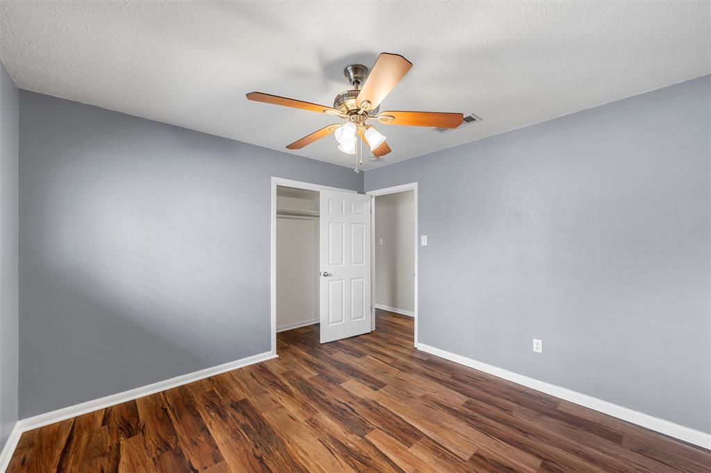 2208 Lake Forest Drive Waco, TX 76708 - Photo 17 of 28 a view of a room with a ceiling fan and wooden floor