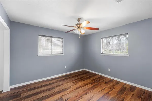 a view of a room with wooden floor and a window