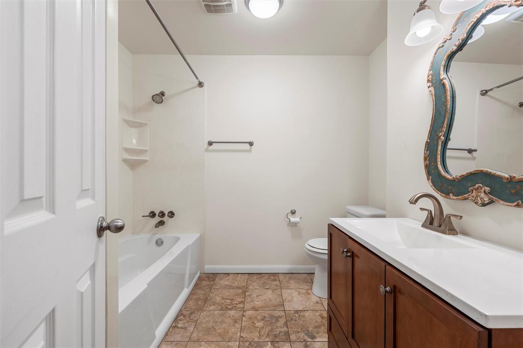 2208 Lake Forest Drive Waco, TX 76708 - Photo 24 of 28 a bathroom with a sink a toilet and shower