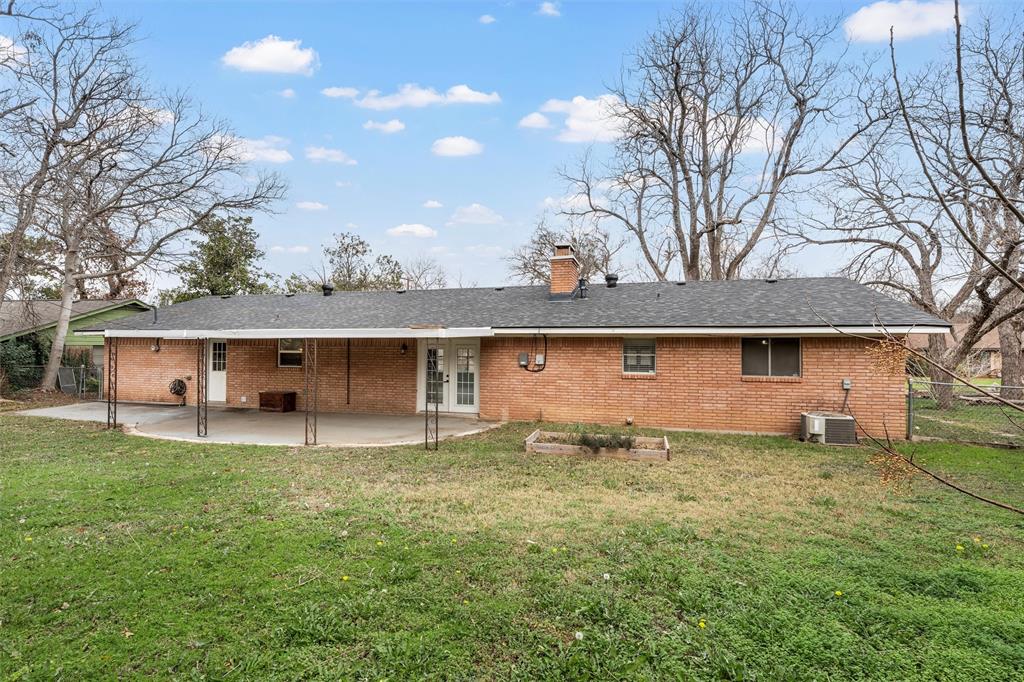 2208 Lake Forest Drive Waco, TX 76708 - Photo 27 of 28 a front view of a house with a yard and garage