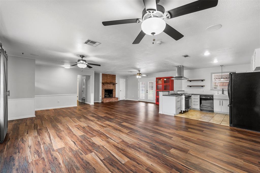 2208 Lake Forest Drive Waco, TX 76708 - Photo 6 of 28 a view of a kitchen with a refrigerator and a ceiling fan