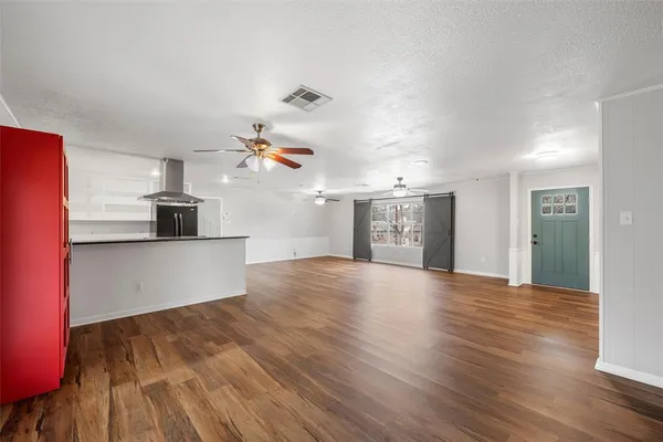 a view of a kitchen with wooden floor and a sink
