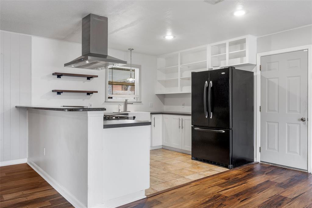 2208 Lake Forest Drive Waco, TX 76708 - Photo 10 of 28 a kitchen with granite countertop a refrigerator and a stove top oven