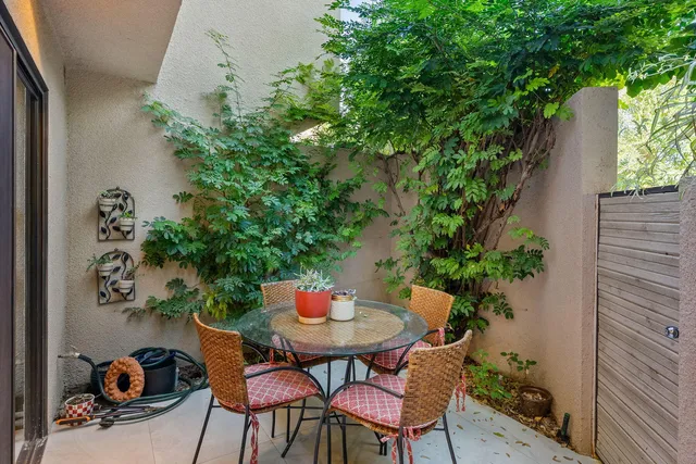 a dining room with furniture and a potted plant