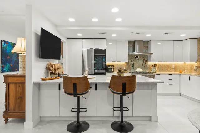 a stove top oven sitting inside of a kitchen