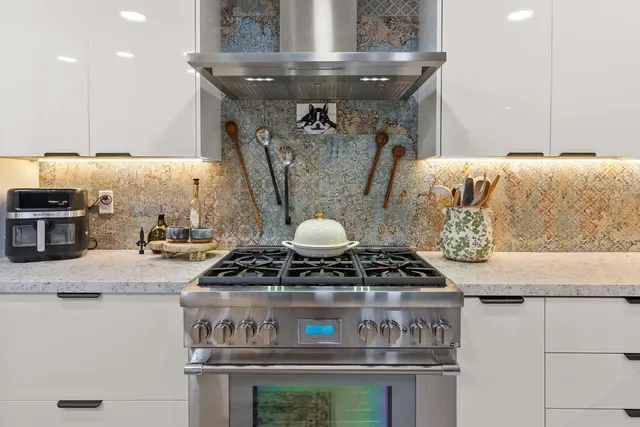 a kitchen with a sink counter top space and stainless steel appliances