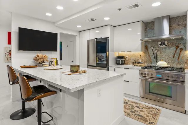 a kitchen with granite countertop cabinets stainless steel appliances and sink