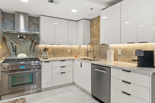 a bathroom with a granite countertop sink a mirror and a shower