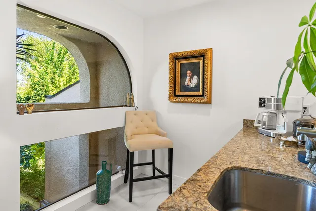 a view of a balcony with chair and potted plant