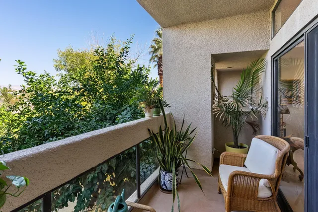 a bedroom with furniture and large windows