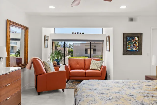a bedroom with furniture and a flat screen tv