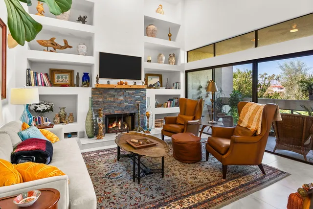 a living room with furniture fireplace and a flat screen tv