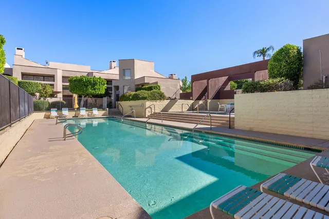 a view of a patio with table and chairs and a barbeque