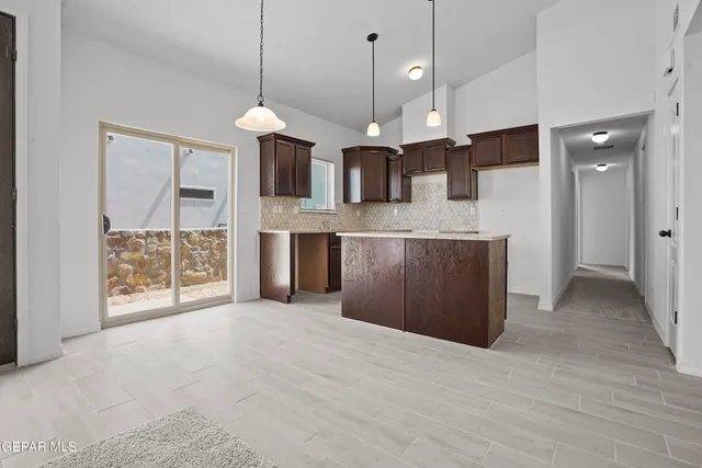 a view of a kitchen with a sink and a chandelier