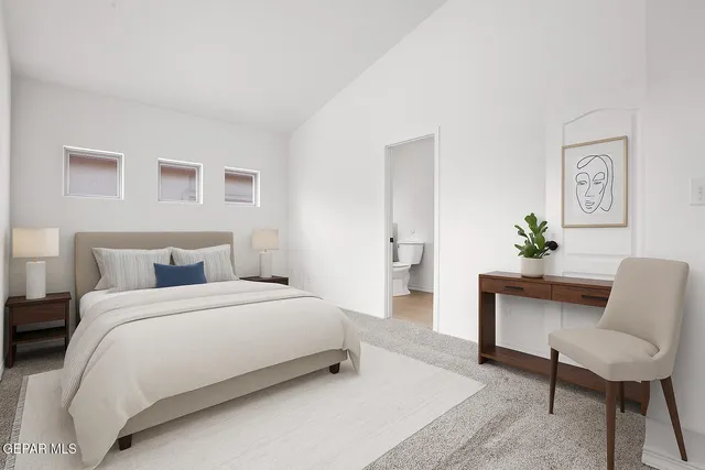 a bedroom with a bed and a couch