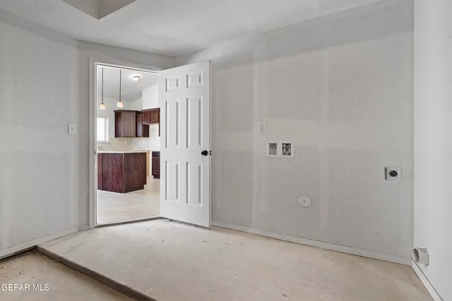 a view of a room with wooden floor and cabinet