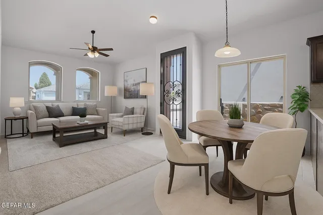 a living room with furniture and a chandelier