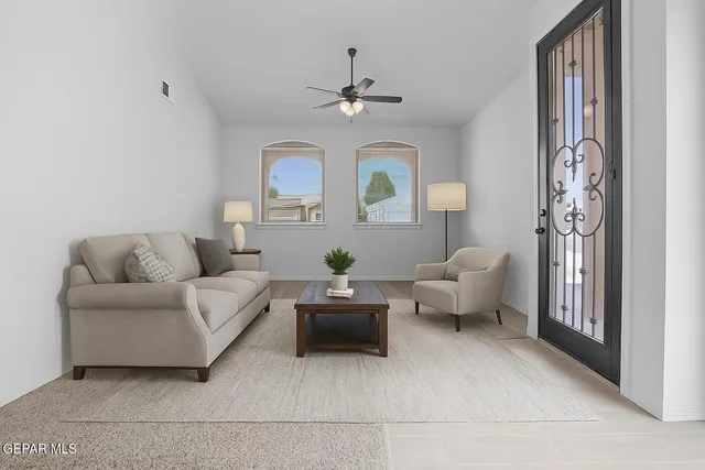 a living room with furniture and a chandelier