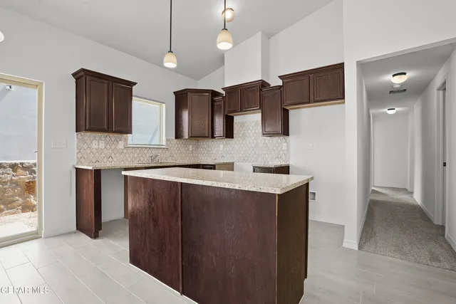 a kitchen with kitchen island a sink stainless steel appliances and cabinets