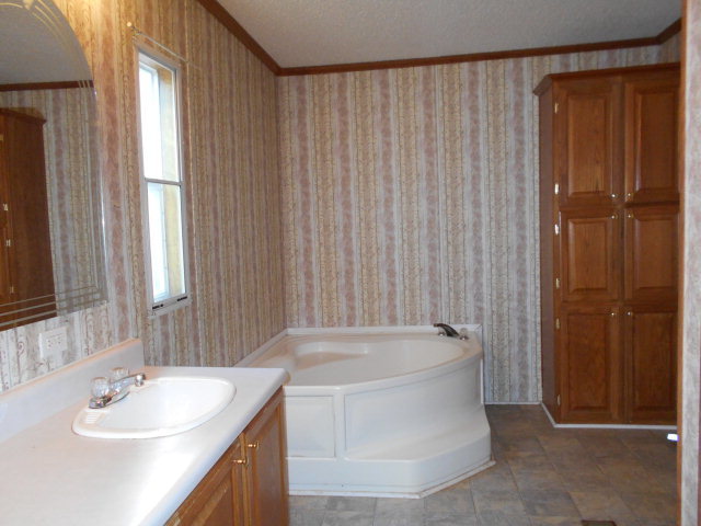 972 Old Indian Springs Road, Unit 4 Forsyth, GA 31029 - Photo 2 of 10 a bathroom with a sink a bathtub and shower