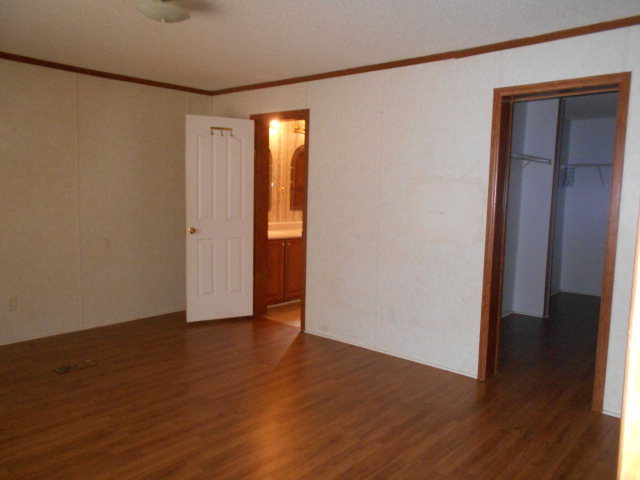 972 Old Indian Springs Road, Unit 4 Forsyth, GA 31029 - Photo 4 of 10 a view of an empty room with wooden floor and closet