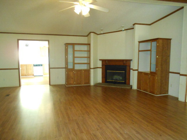 972 Old Indian Springs Road, Unit 4 Forsyth, GA 31029 - Photo 5 of 10 a view of empty room with wooden floor and fireplace