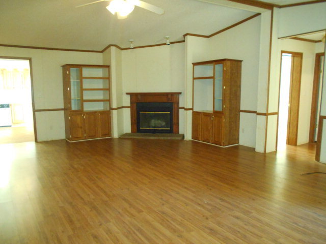 972 Old Indian Springs Road, Unit 4 Forsyth, GA 31029 - Photo 6 of 10 a view of a livingroom with wooden floor and a fireplace