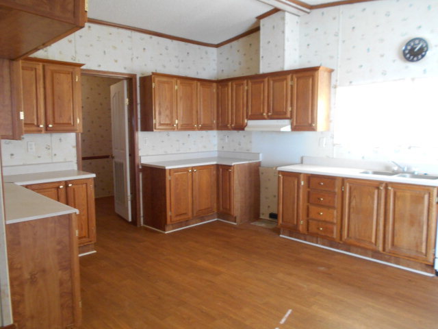 972 Old Indian Springs Road, Unit 4 Forsyth, GA 31029 - Photo 7 of 10 a kitchen with stainless steel appliances granite countertop a refrigerator and a stove top oven