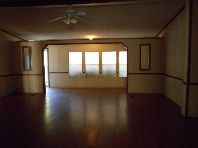 972 Old Indian Springs Road, Unit 4 Forsyth, GA 31029 - Photo 9 of 10 an empty room with wooden floor and windows