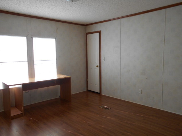 972 Old Indian Springs Road, Unit 4 Forsyth, GA 31029 - Photo 10 of 10 a view of an empty room with wooden floor and a window