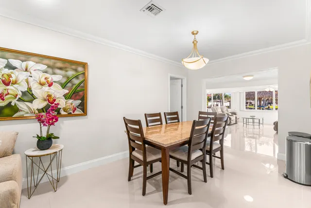 a dining room with furniture and wooden floor