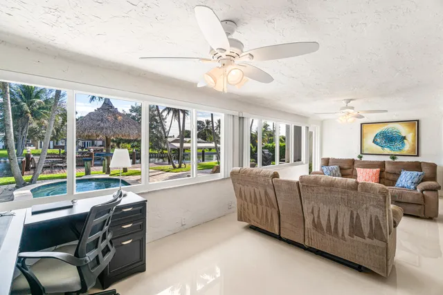 a living room with furniture and a large window with outer view