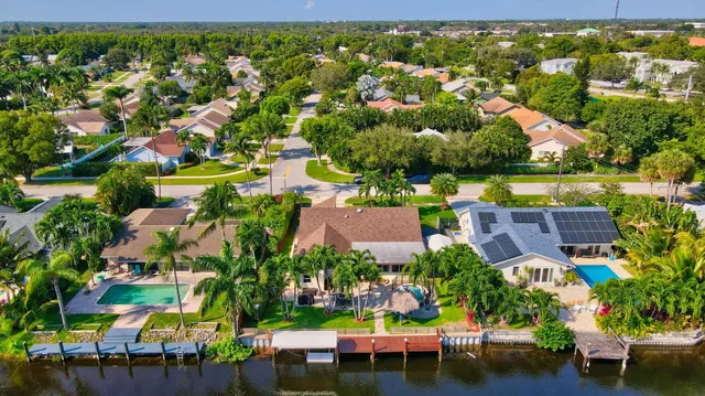 an aerial view of residential houses with outdoor space and swimming pool
