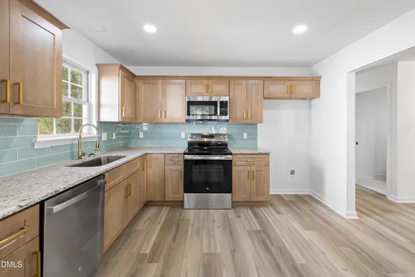 a kitchen with a stove a sink and a refrigerator