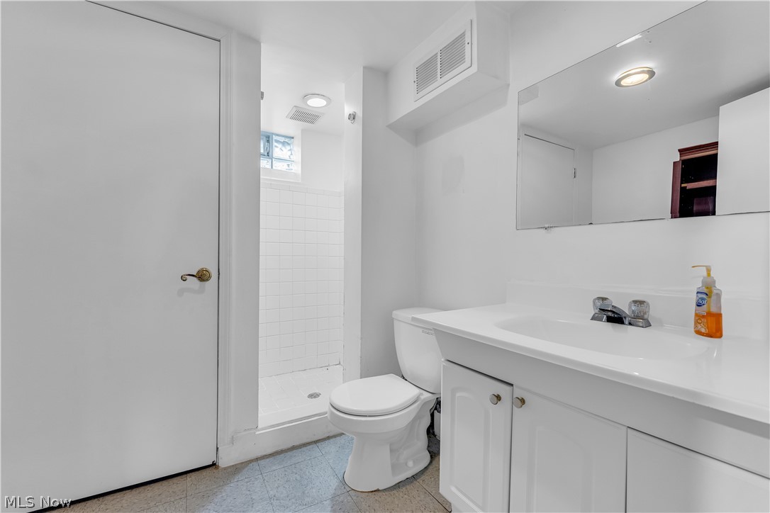 3842 Wallingford Road South Euclid, OH 44121 - Photo 30 of 31 Bathroom featuring walk in shower, vanity, toilet, and tile floors
