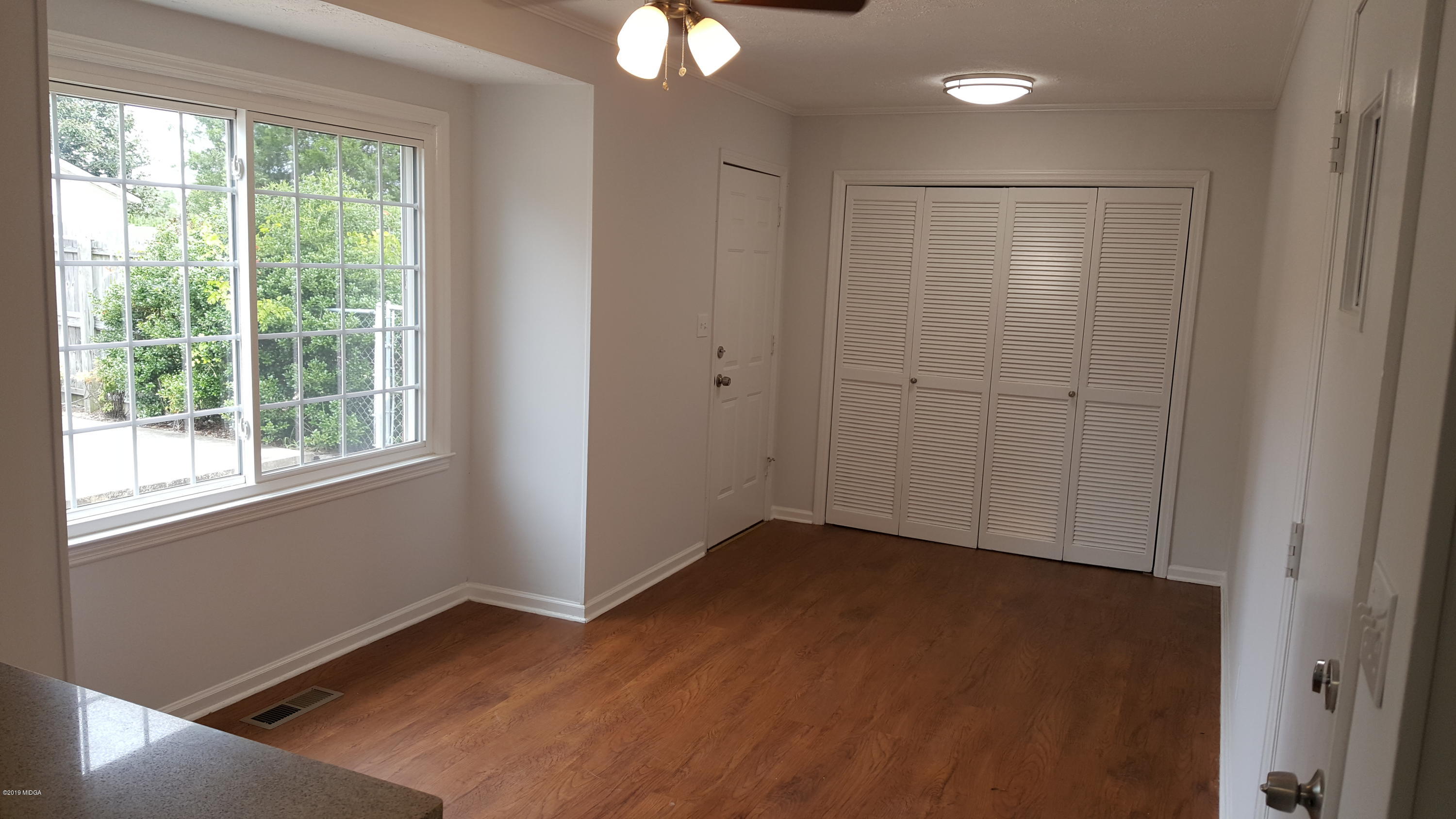5545 Marshall Mill Road Lizella, GA 31052 - Photo 4 of 12 a view of an empty room with wooden floor and a window