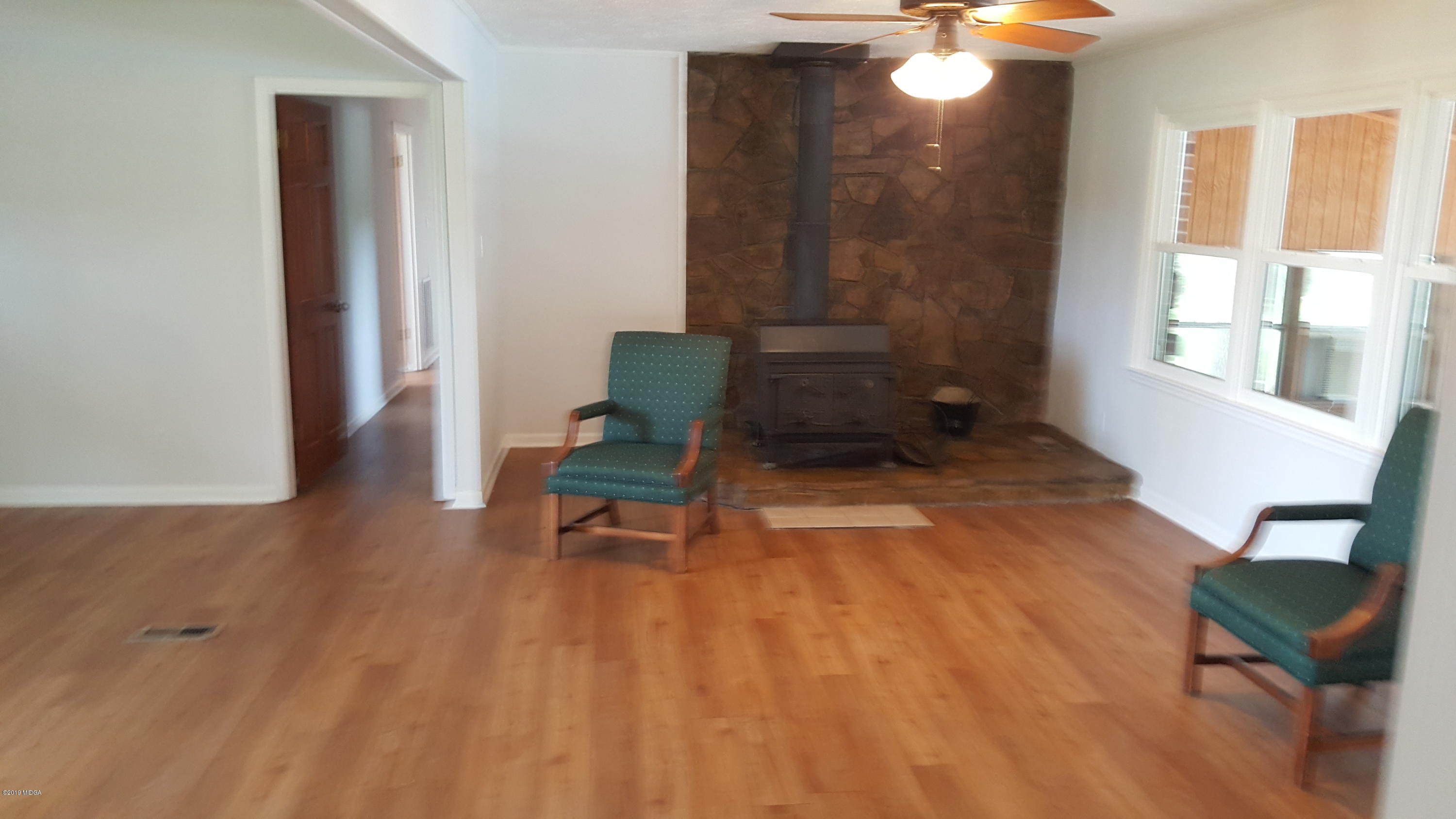 5545 Marshall Mill Road Lizella, GA 31052 - Photo 5 of 12 a view of a livingroom with furniture and wooden floor