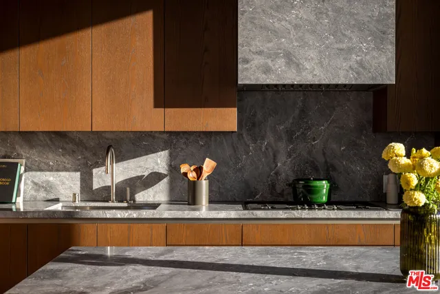 a view of a sink and room with wooden floor