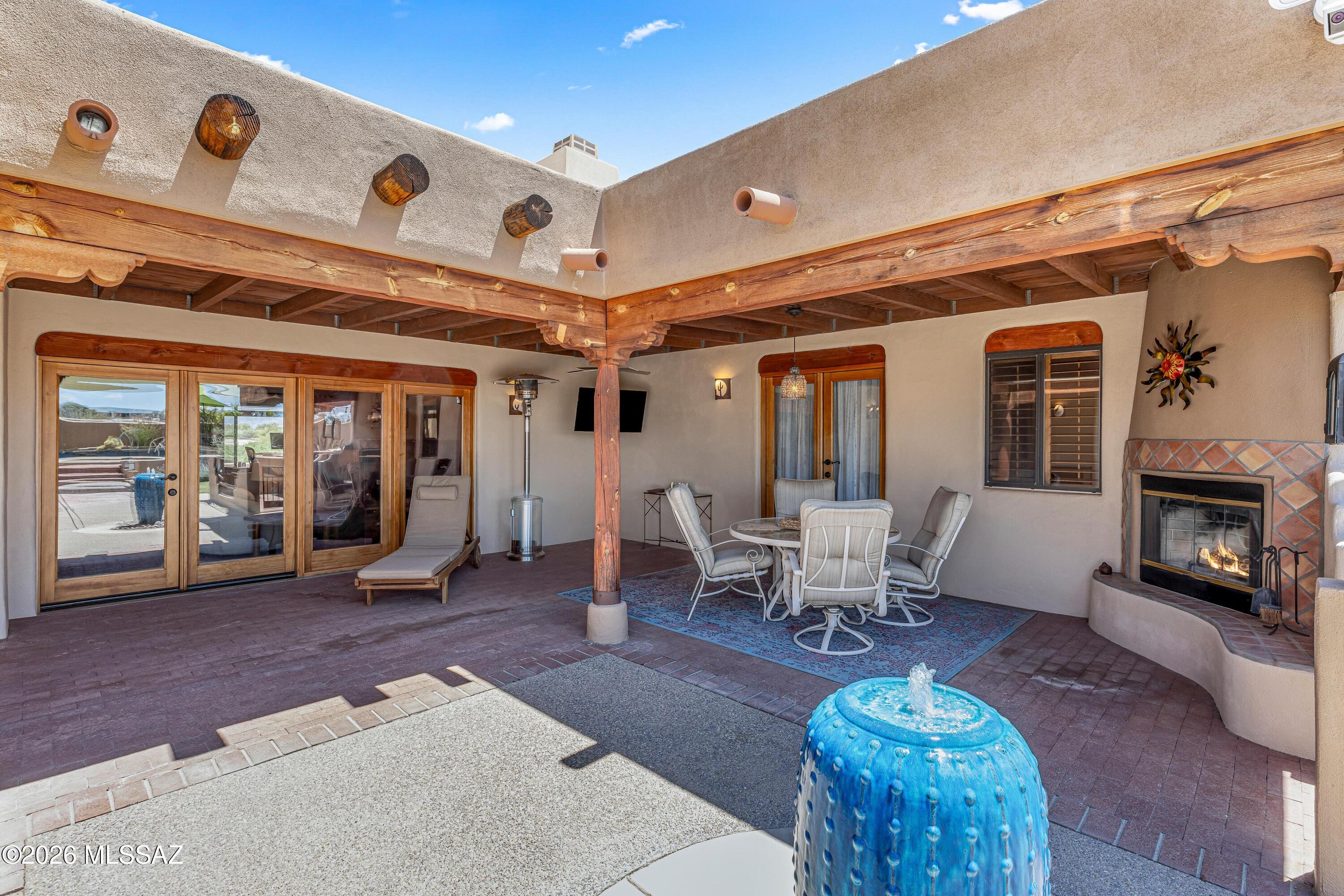 11160 East Golf Links Road Tucson, AZ 85730 - Photo 29 of 51 Enjoy a meal in the shade next to your outdoor fireplace and fountain.