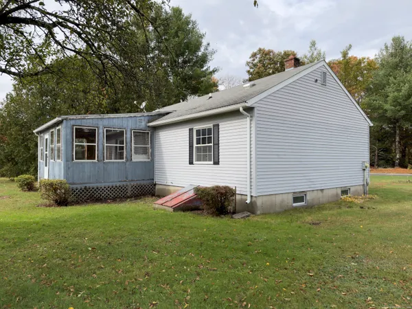 a view of front of house with a yard