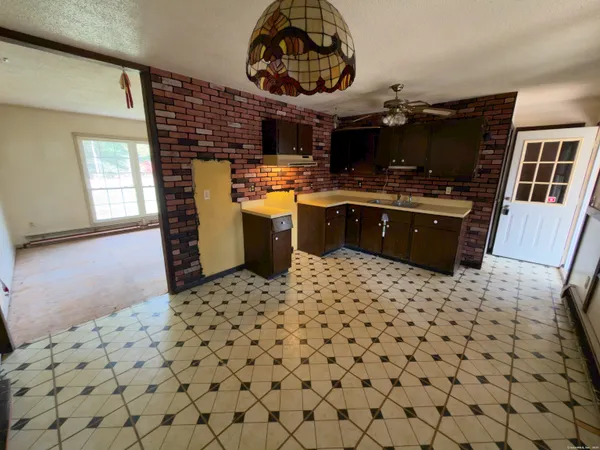 a kitchen with a sink a stove and a wooden cabinets
