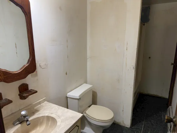 a bathroom with a toilet and a mirror