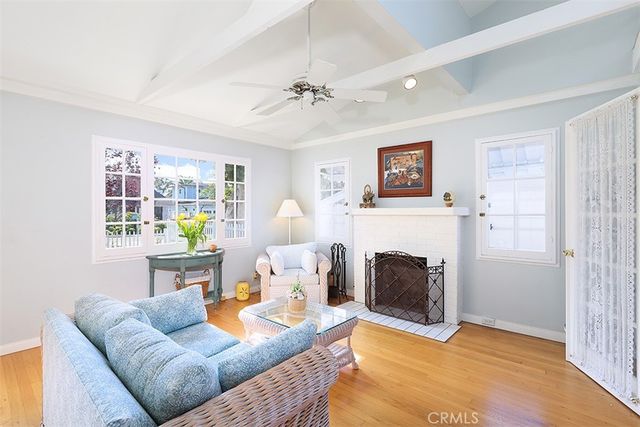 a living room with furniture a fireplace and a table