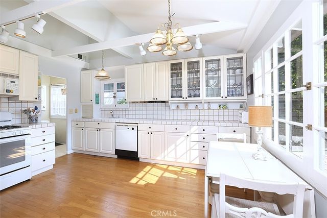 a large white kitchen with a large window