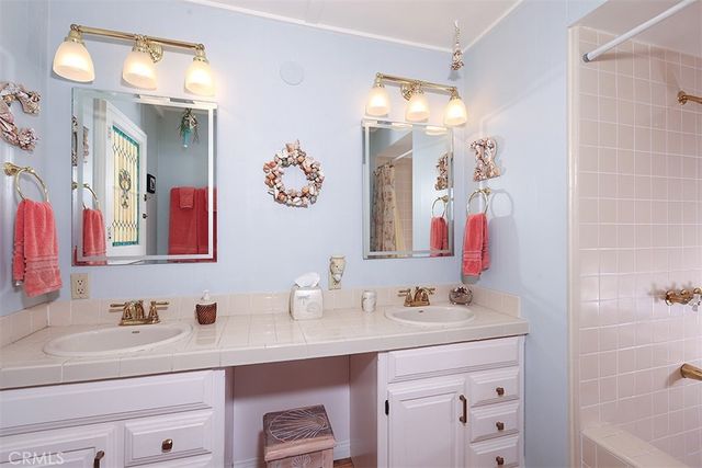 a bathroom with a sink vanity and a mirror