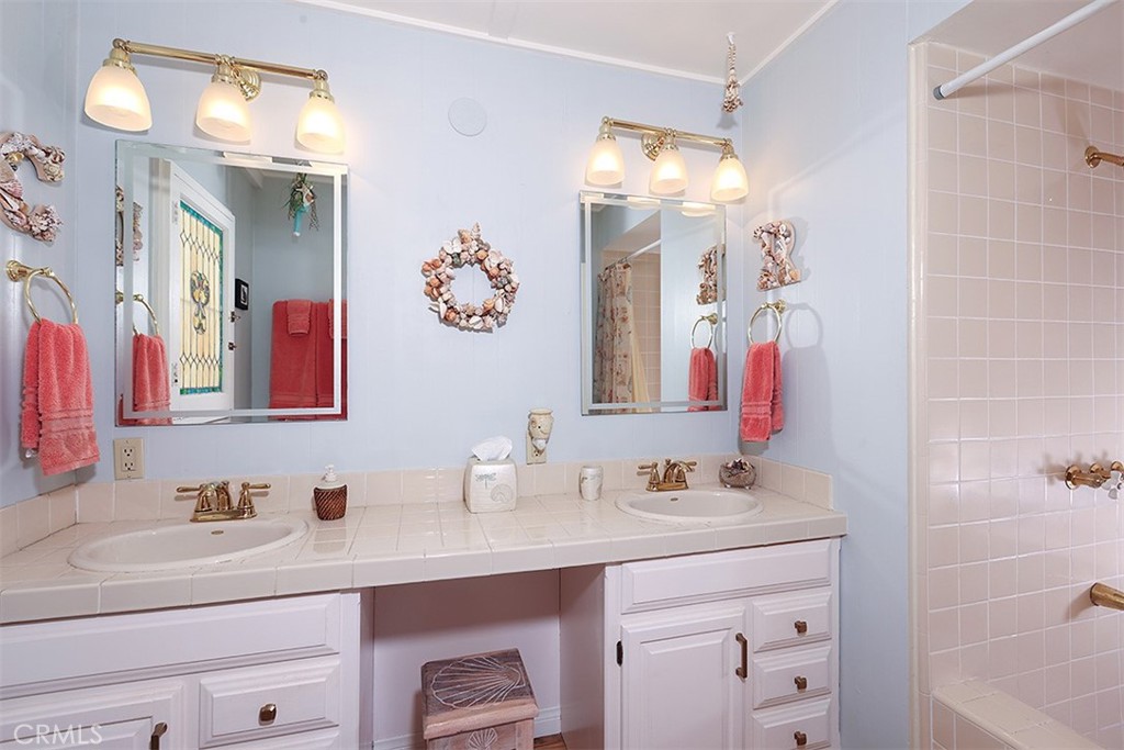 432 Shadow Lane Laguna Beach, CA 92651 - Photo 8 of 22 a bathroom with a sink vanity and a mirror