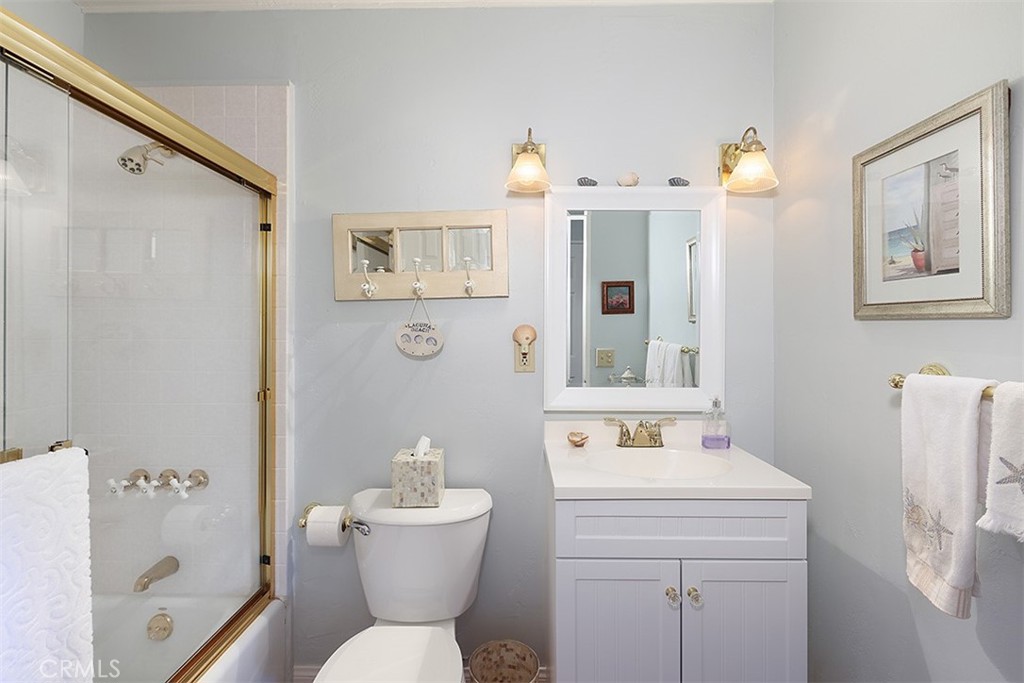 432 Shadow Lane Laguna Beach, CA 92651 - Photo 10 of 22 a bathroom with a sink a mirror a toilet and a shower